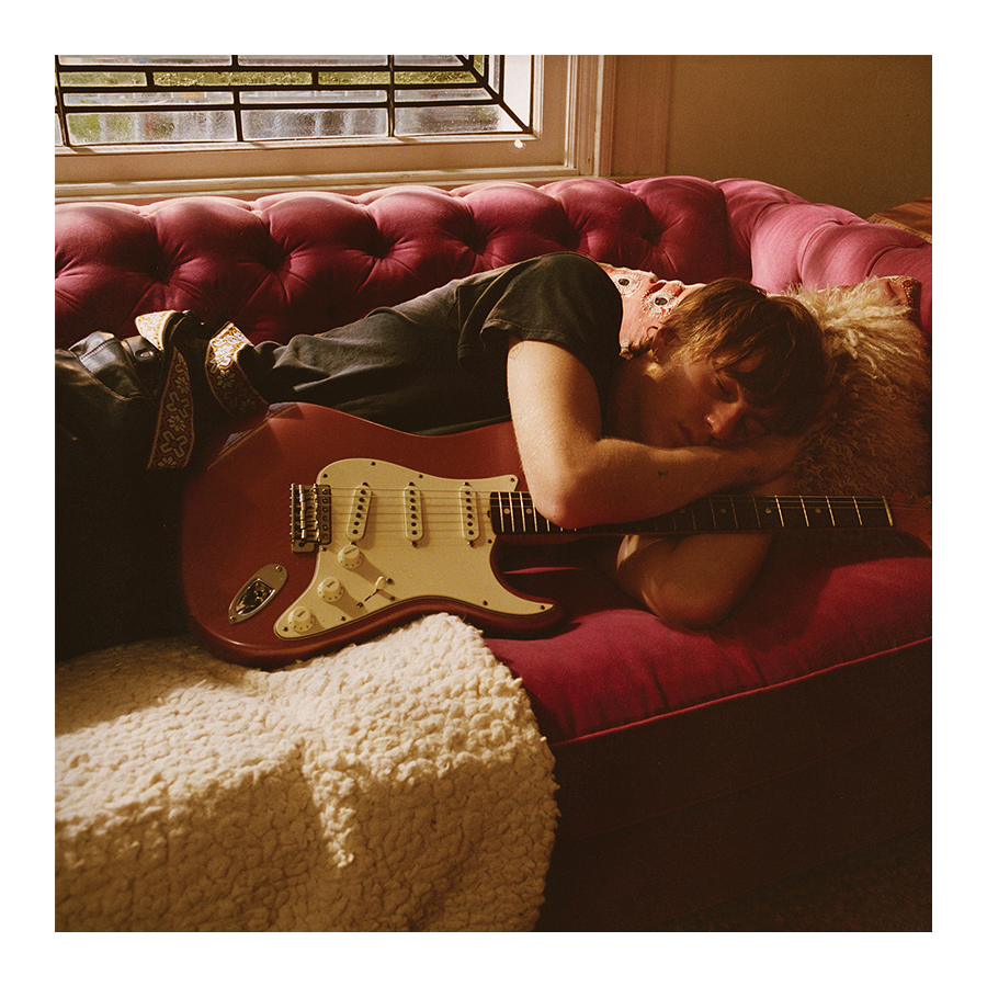 Image of Malcolm Todd – Do That Again vinyl insert featuring artwork of Malcolm Todd lying on a red sofa holding a red strat guitar